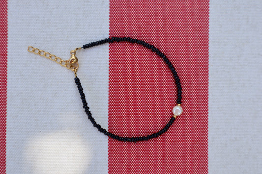 Armband: gouden parel - zwart